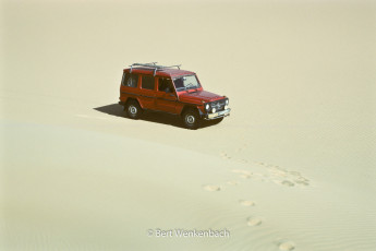 Our loyal Mecedes G is waiting while we climb one of the sand dunes